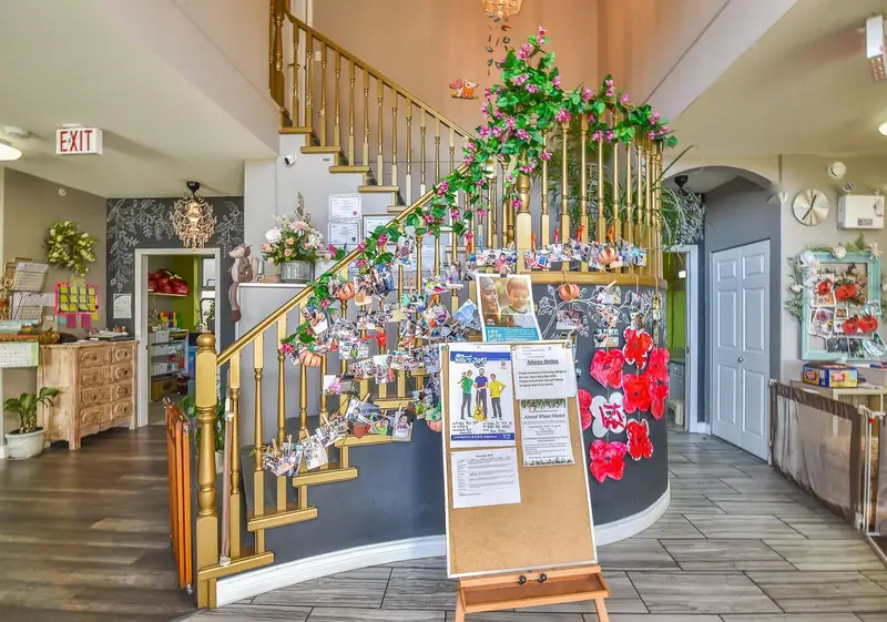 The entry hall with its staircase and a display board of children's photos