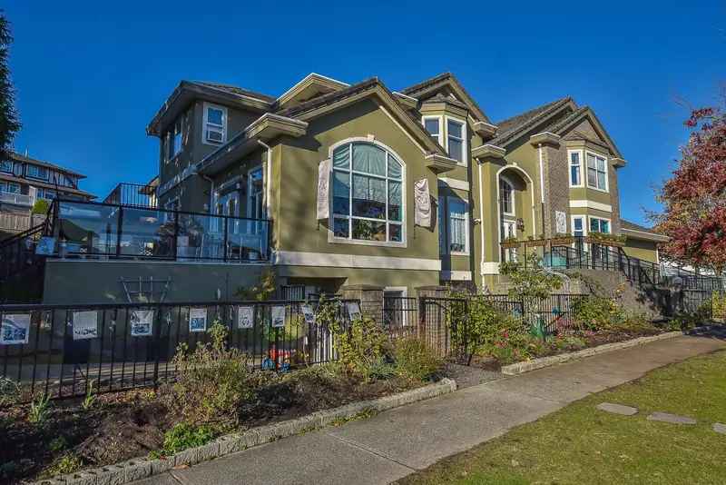 The exterior of La Vie Est Belle Childcare Centre with its fenced front yard