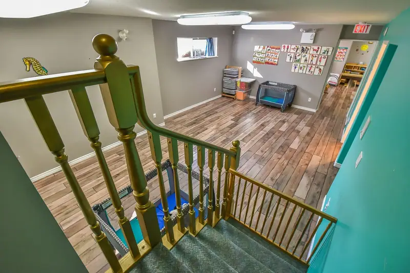The upstairs landing and open play space with a wooden railing