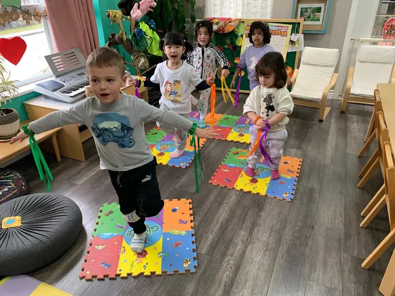 Children stepping across a foam mat obstacle path
