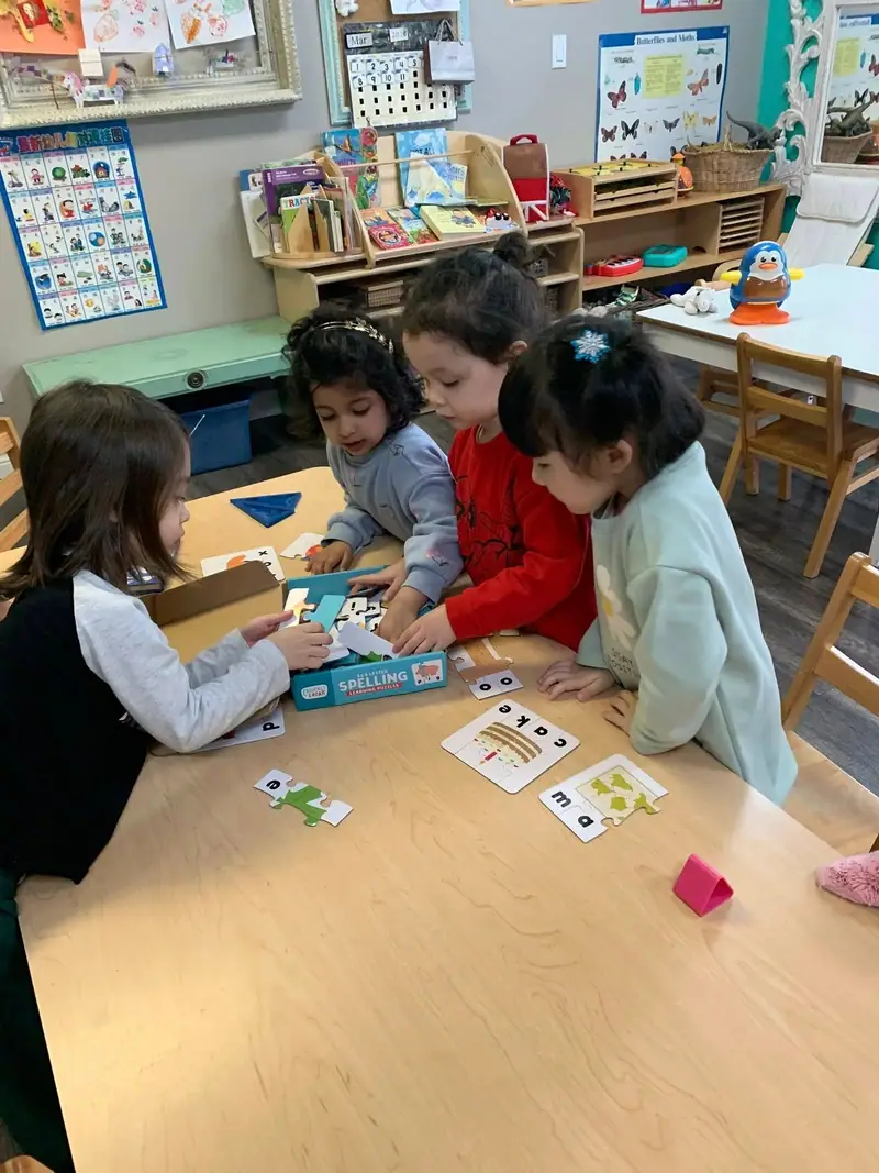 Four children playing a picture-card matching game together at a table