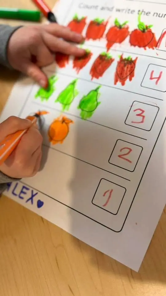A child's counting worksheet with painted vegetables and numbers