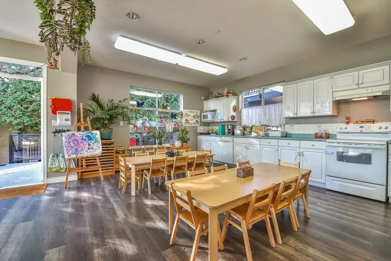 Wooden dining tables beside the centre's kitchen counter