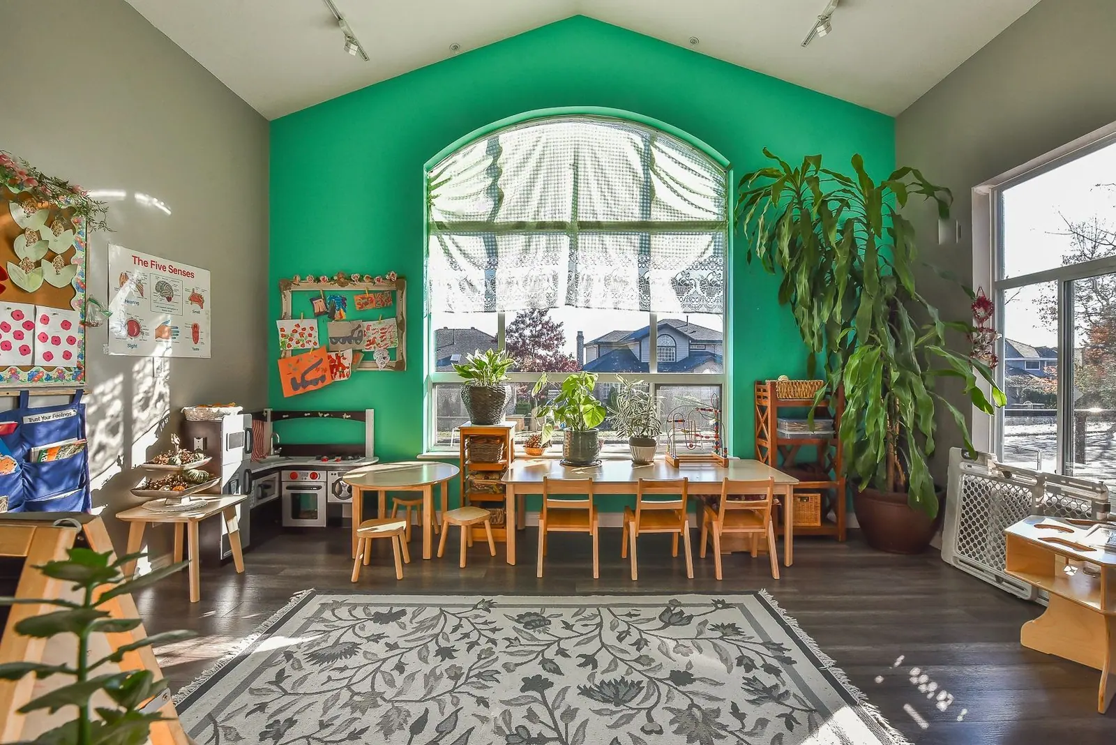 A wide view of the green classroom with natural light across the floor