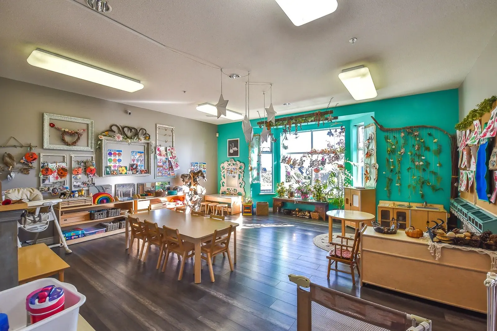 The main learning room, with long wooden tables and teal walls
