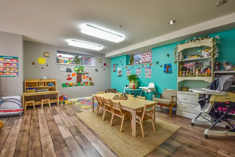A learning room with a jute rug, low table and soft seating