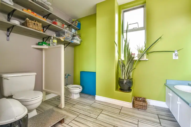 A children's washroom with two child-height toilets